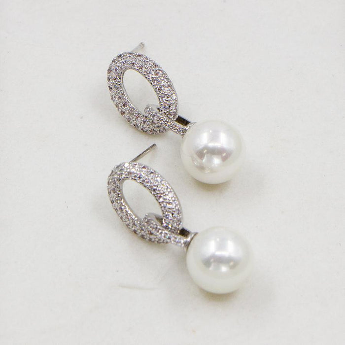 Faux pearl earrings with cubic zirconia link post