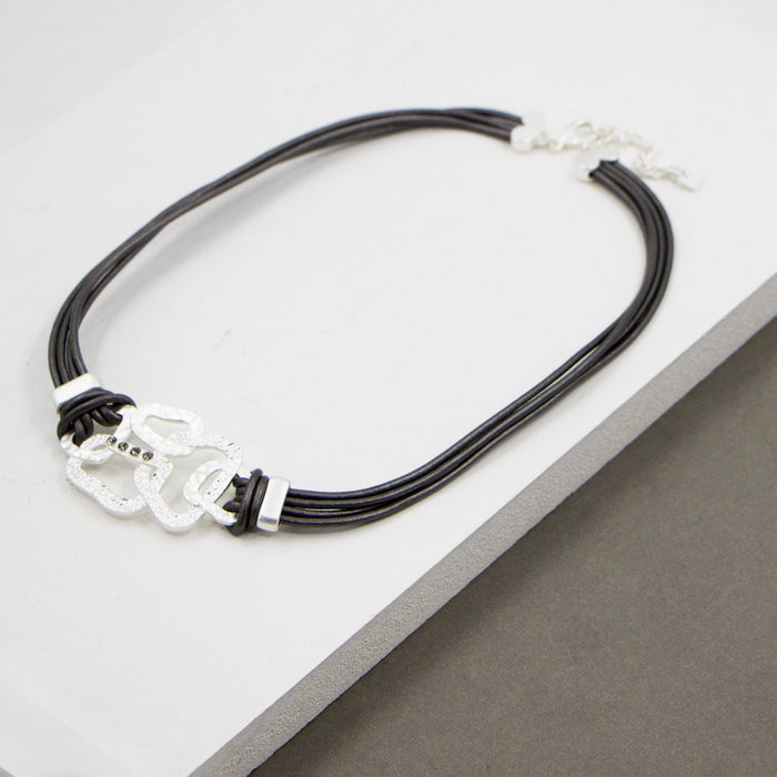 Organic shapes feature leather necklace