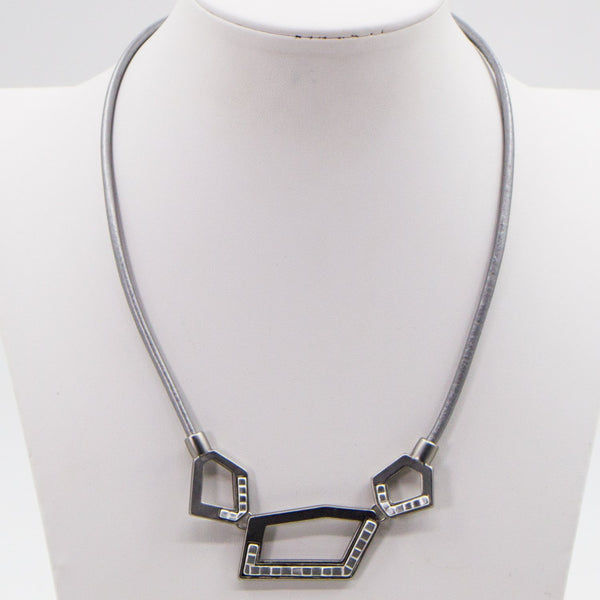 Cut out geometric shapes on leather necklace