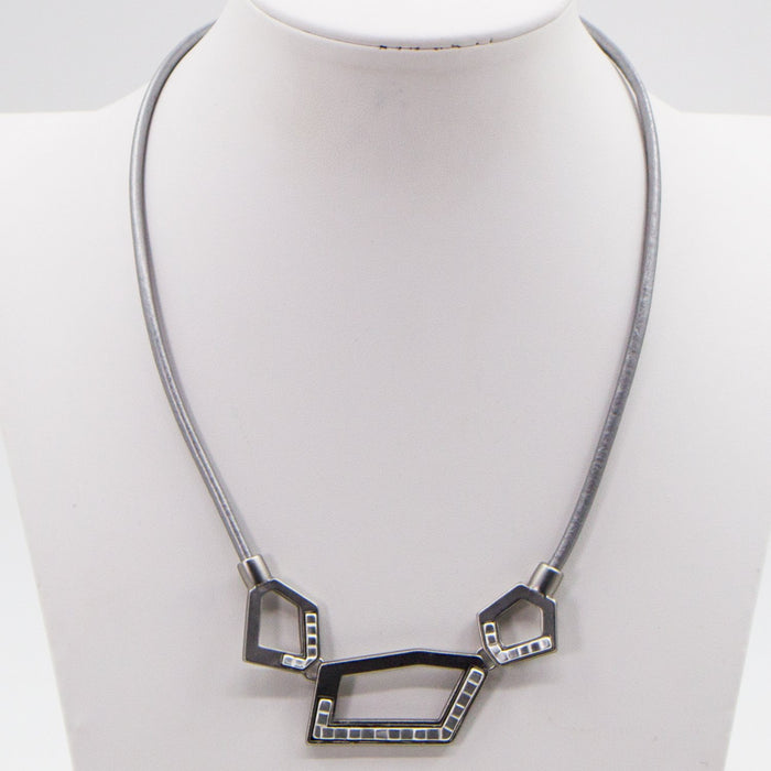 Cut out geometric shapes on leather necklace